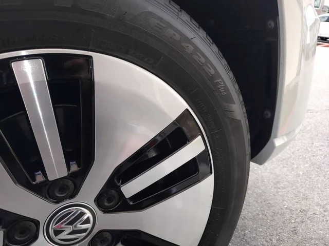 The same two-tone Volkswagen wheel after cosmetic repair, with a refinished rim edge